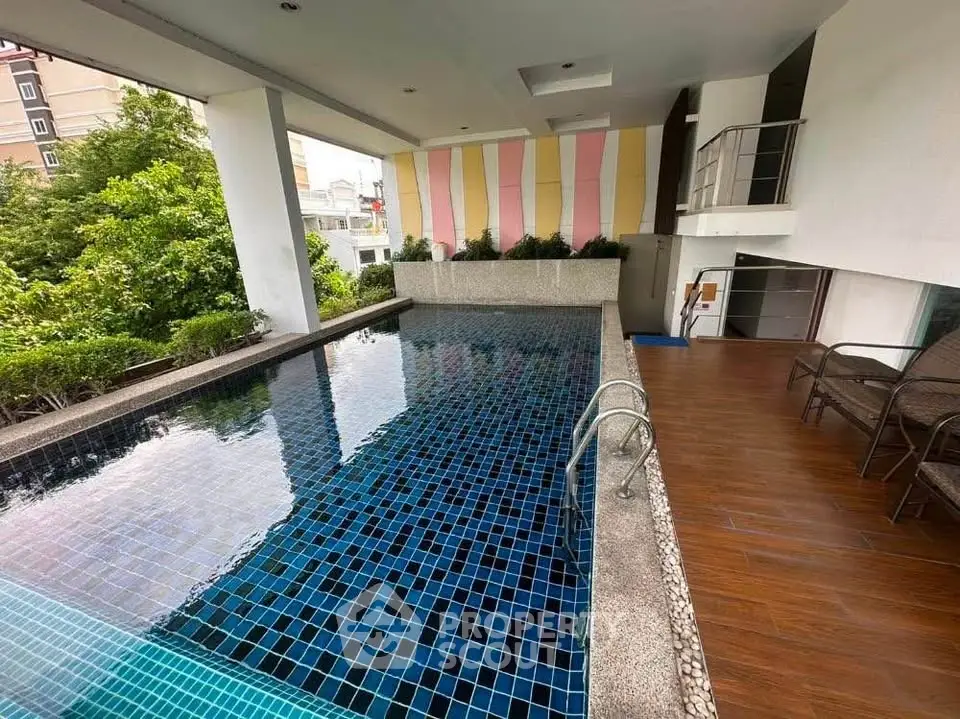 Luxurious indoor pool area with modern design and seating, perfect for relaxation and leisure.