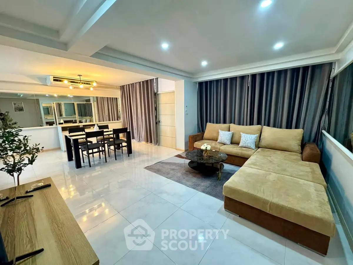 Spacious modern living room with open layout and elegant dining area, perfect for entertaining.