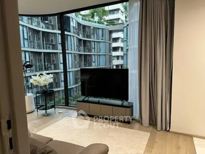 Modern living room with large windows offering stunning city view, sleek furniture, and elegant decor.