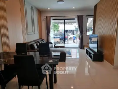 Spacious modern living room with elegant dining area and large windows for natural light.