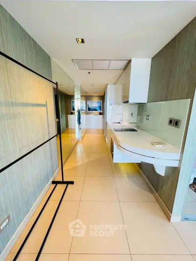 Modern kitchen with sleek design and open layout, featuring minimalist cabinetry and stylish flooring.