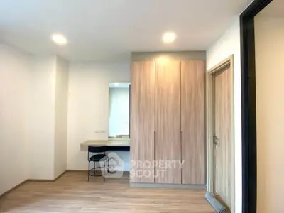 Modern bedroom with wooden flooring and built-in wardrobe