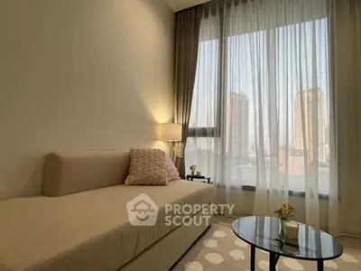 Cozy living room with elegant sofa and city view through large window