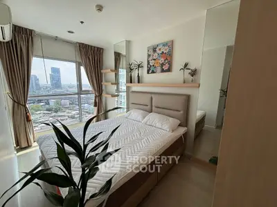 Modern bedroom with city view, stylish decor, and ample natural light