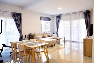 Spacious modern living room with elegant decor and ample natural light, perfect for relaxation and entertainment.