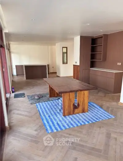 Spacious modern living room with wooden flooring and stylish furniture.