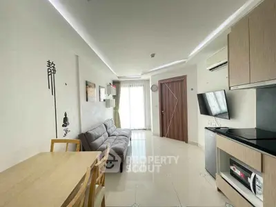 Modern living room with sleek kitchen and stylish decor, perfect for urban living.