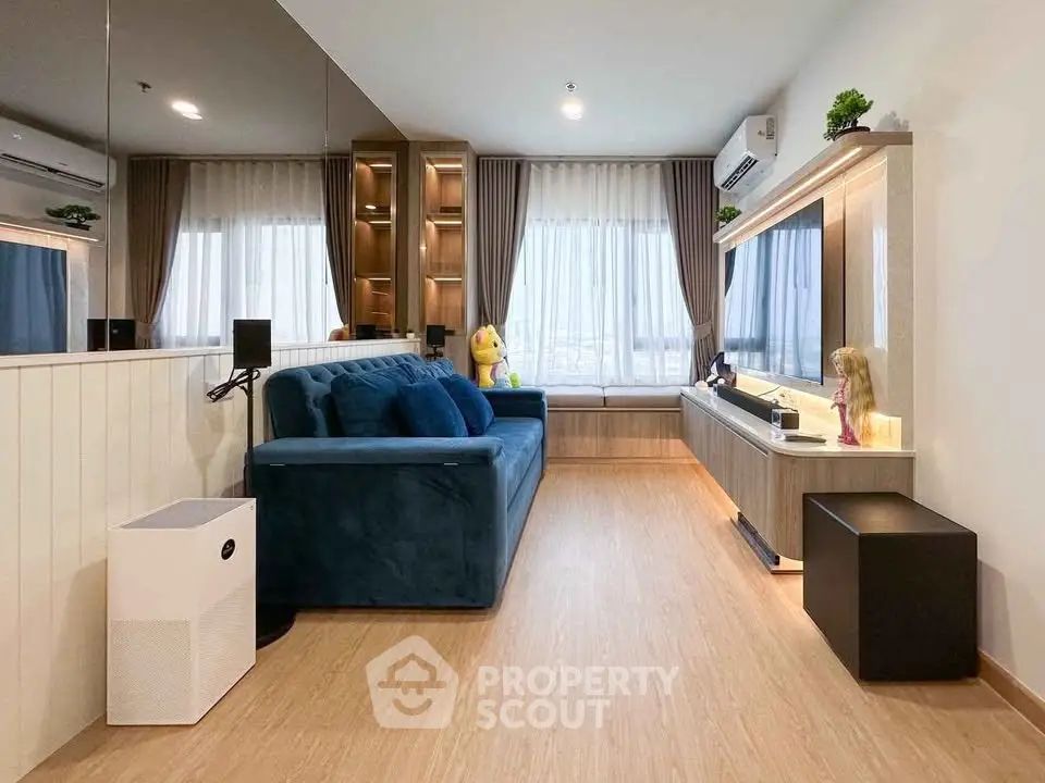 Modern living room with stylish decor, large windows, and cozy seating area.