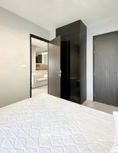 Modern bedroom with sleek design and cozy ambiance in a contemporary apartment.