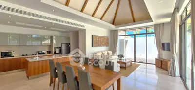 Luxurious open-plan living room with modern kitchen and elegant dining area, featuring high ceilings and natural light.