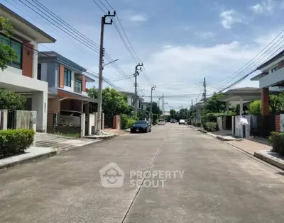 Charming suburban street with modern houses and lush greenery, perfect for family living.