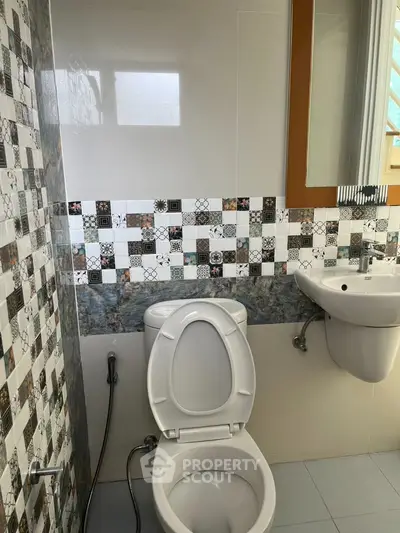 Modern bathroom with stylish tile design and sleek fixtures.