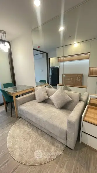 Modern living room with stylish sofa and dining area in a cozy apartment.