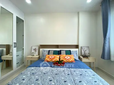 Modern bedroom with stylish decor and ample natural light