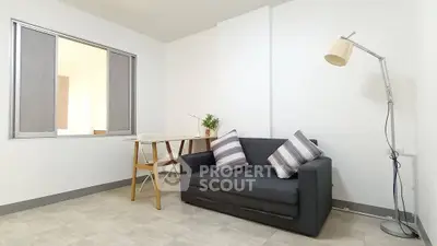 Modern minimalist living room with cozy sofa and stylish floor lamp.