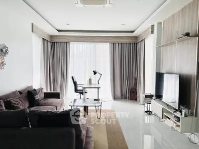 Spacious modern living room with natural light, cozy seating, and stylish decor, perfect for relaxation and entertainment.
