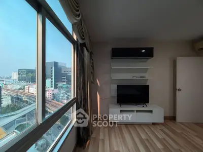 Modern living room with city view and sleek entertainment unit