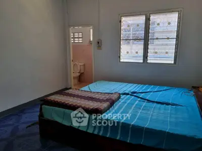 Cozy bedroom with attached bathroom and natural light