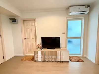 Modern living room with TV and air conditioning in a cozy apartment.