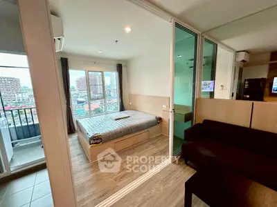 Modern studio apartment with balcony and city view, featuring sleek wooden flooring and contemporary furnishings.