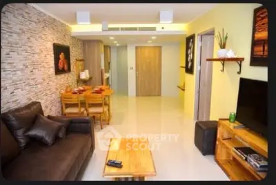 Modern living room with stylish decor and open layout, featuring a cozy seating area and dining space.