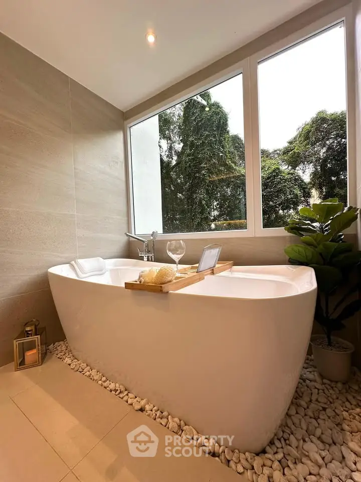 Luxurious bathroom with freestanding tub and scenic window view