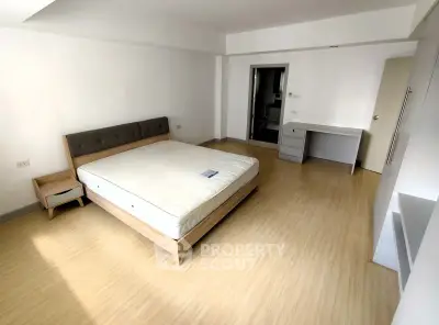 Spacious bedroom with modern furnishings and natural light