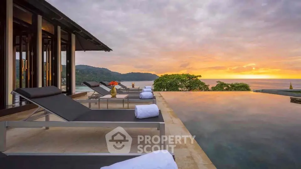 Luxurious infinity pool with stunning ocean view at sunset, perfect for relaxation and leisure.