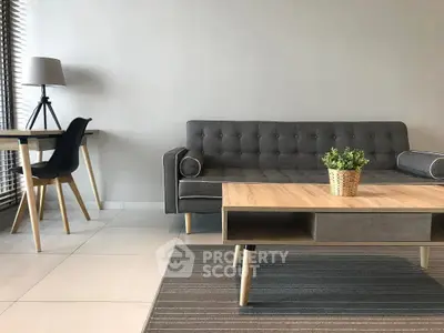 Modern living room with stylish gray sofa and wooden coffee table, perfect for contemporary urban living.