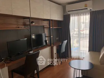 Modern living room with workspace and city view, featuring stylish furniture and natural light.
