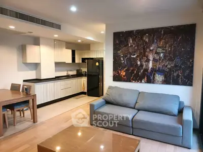 Modern open-plan living room with kitchen and cityscape artwork