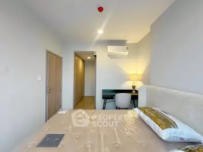 Modern bedroom with minimalist decor and natural lighting, featuring a cozy bed and a stylish desk area.