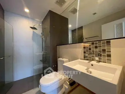 Modern bathroom with sleek fixtures and glass shower enclosure