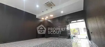 Spacious modern interior with unique black walls and patterned flooring