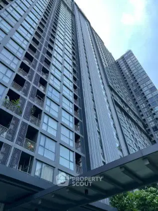 Stunning high-rise building exterior with modern architectural design and expansive windows.