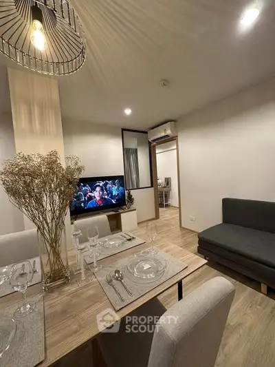 Modern living room with dining area, stylish decor, and cozy ambiance in a contemporary apartment.