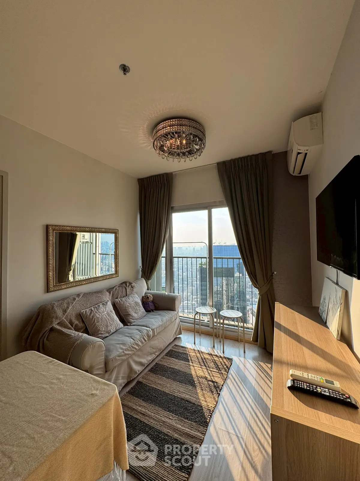 Chic living room with elegant decor and stunning city view from balcony.