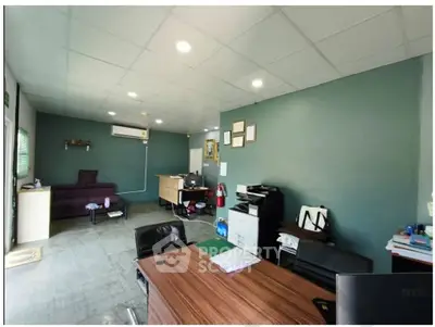 Spacious office interior with modern furniture and ample lighting, perfect for a productive work environment.