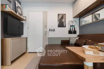 Modern living room with stylish decor and comfortable seating in a compact space.