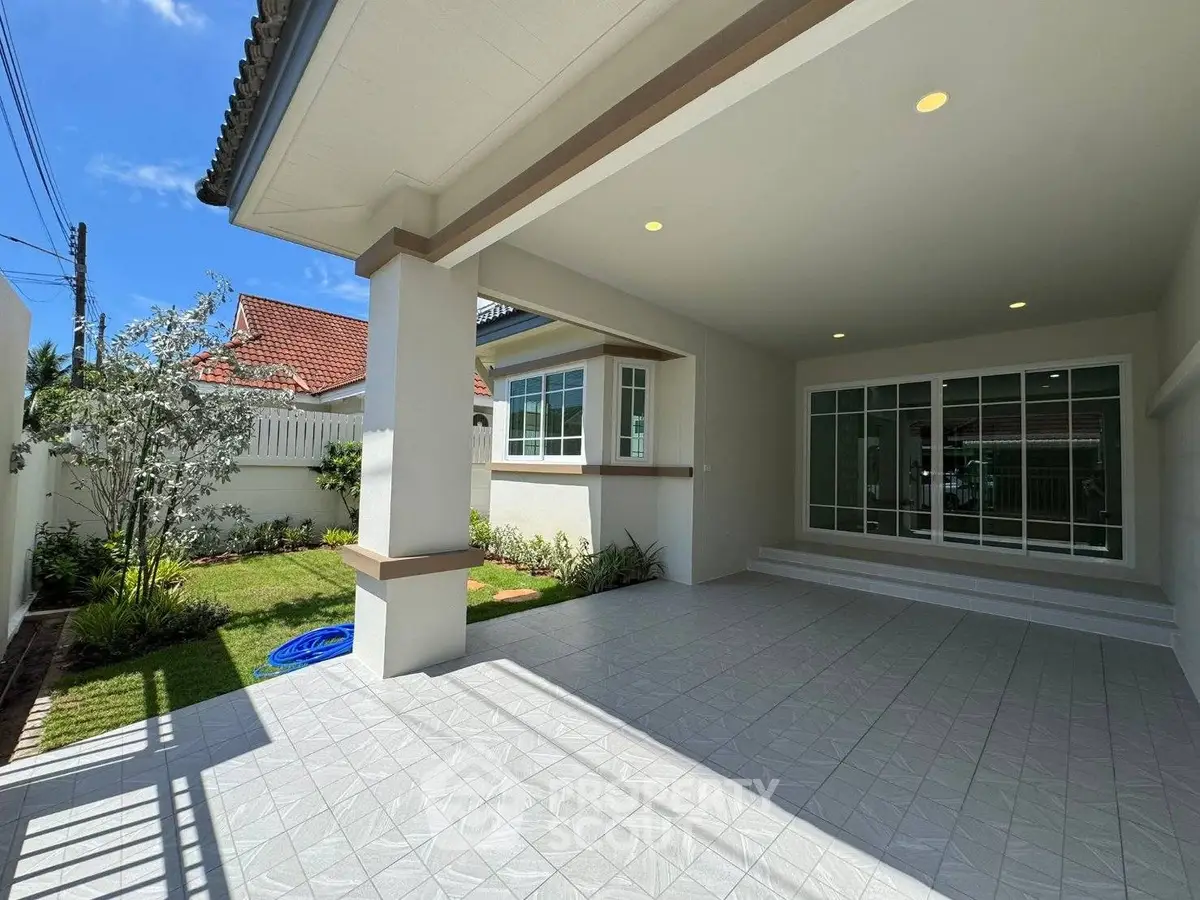 Spacious covered patio with garden view in modern residential property