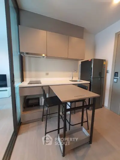 Modern compact kitchen with sleek design and integrated appliances