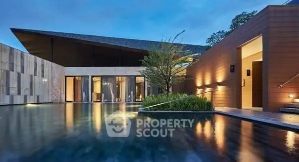 Luxurious modern villa with stunning pool and elegant architecture at dusk.