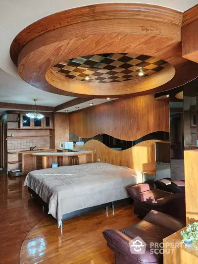 Luxurious bedroom with unique wooden ceiling and cozy seating area