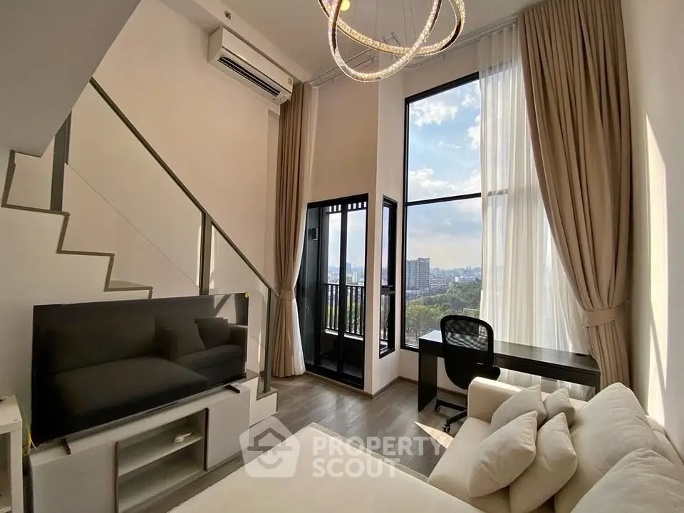 Modern loft apartment with high ceilings, large windows, and city view balcony.