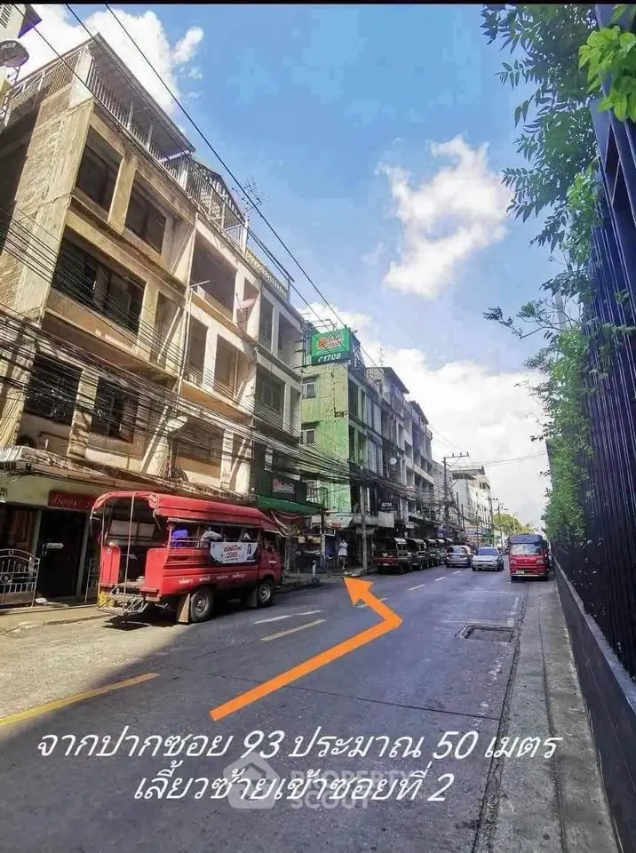 Urban street view with commercial buildings and clear blue sky, ideal for business opportunities.