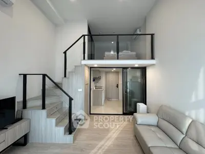 Modern loft apartment with stylish staircase and cozy living area