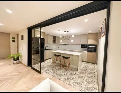 Modern open-layout kitchen with island and stylish lighting in a contemporary home.