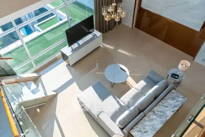 Spacious modern living room with large windows and elegant decor