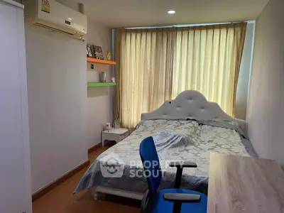 Cozy bedroom with modern decor and ample natural light