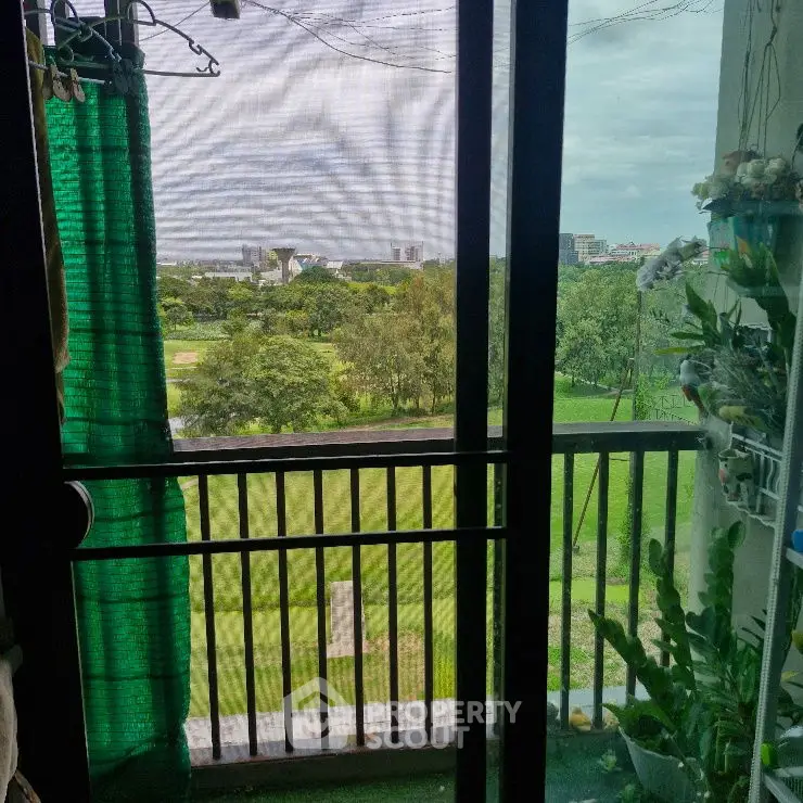 Charming balcony with lush green view, perfect for relaxation and enjoying nature.